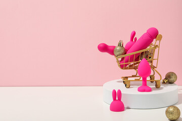 Sex toys with Christmas decorations and shopping cart. - obrazy, fototapety, plakaty