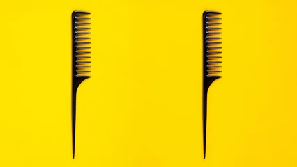  Black hair comb isolated on yellow background © apinya