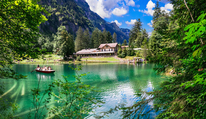 amazing Swiss mountain lakes - beautiful fairytale Blausee lake with clear trasparent waters. near Kandersteg village. Switzerland  travel and scenery - obrazy, fototapety, plakaty