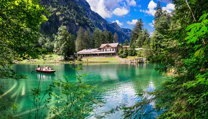 Schilderijen op glas amazing Swiss mountain lakes - beautiful fairytale Blausee lake with clear trasparent waters. near Kandersteg village. Switzerland  travel and scenery © Freesurf