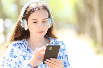 Woman listening to music walking in a park