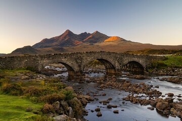River Sligachan with old stone bridge, Cuillin Mountains in the background, Isle of Skye,...