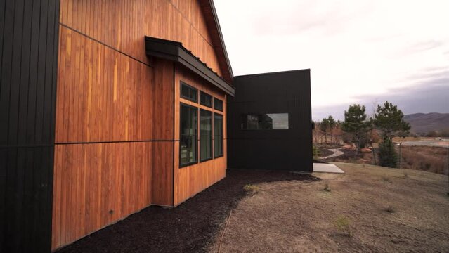 Exterior of a luxury cedar cabin backyard patio deck - panning reveal