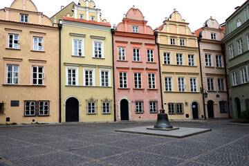 Warsaw, Poland, Europe - facades of townhouses and bell formely installed in St John's Archcathedral, Kanonia square, Old Town - UNESCO World Heritage Site