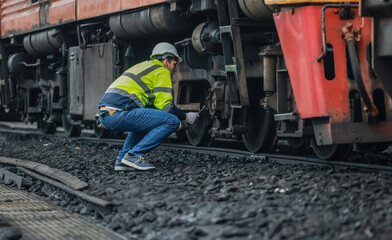 Fototapeta premium Rail technicians identify, repair engine issues, prevent fuel leaks for efficient train operation
