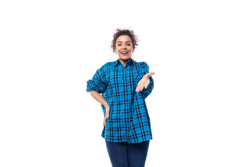 Fototapeta premium european friendly young lady with curly ponytail hairstyle dressed in a blue shirt with a plaid pattern