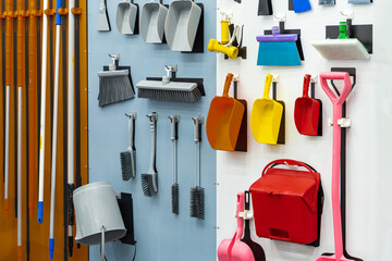 difference type home and garden tool hanging on board such as dustpan mob etc.