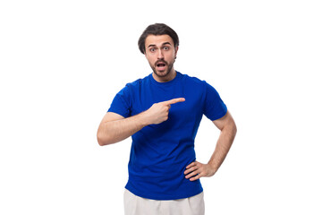 young authentic brunette man with a beard in a blue t-shirt on a white background with copy space