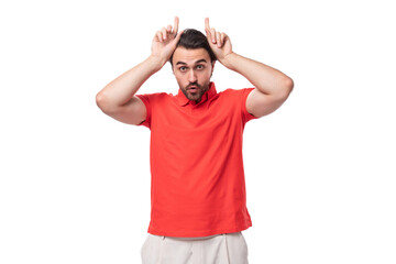 young attractive 35 year old european man with styled haircut and beard making a face with horns