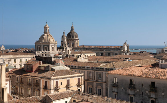 Italy, Sicily, Catania, Residential rooftops with church domes in background