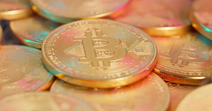 Bitcoin coins rotate around their axis in smoke.