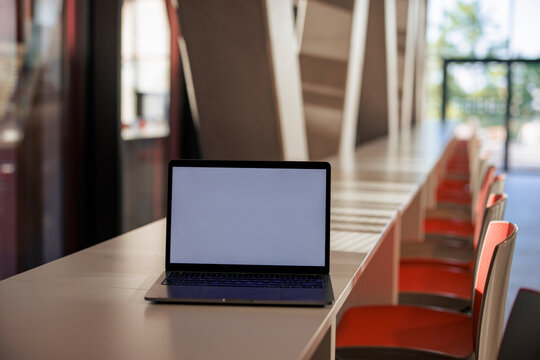 Laptop on table in office cafeteria
