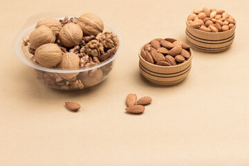 Walnuts in plastic containers. Nuts in wooden boxes.  Plastic pollution and eco-friendly dish.