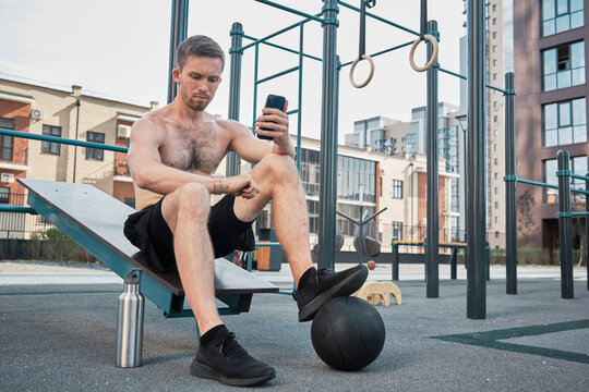 Man using fitness tracker on smart watch at gym