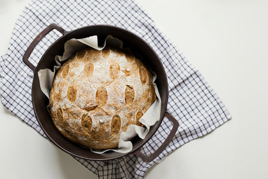 Freshly baked sourdough bread in cast iron cooking pan