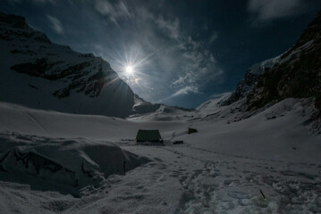 snow covered mountains in full moon