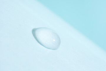 Macro photo of water drop on light blue background