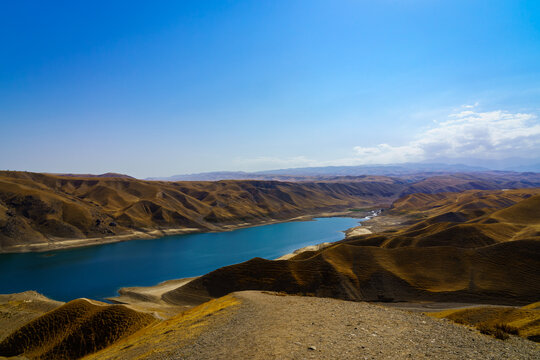 A deserted part of the Zaamin nature reserve in Uzbukistan on a sunny summer day. View of the mountains and reservoir.