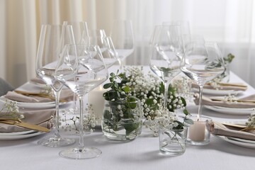 Beautiful table setting with floral decor indoors