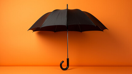 An open umbrella on an orange background with a black color - obrazy, fototapety, plakaty