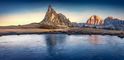 Frozen small lake at the foot of Ra Gusela mountain. Wonderful sunrise in Dolomite Alps. Attractive...