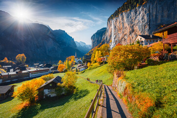 First sunlight glowing Lauterbrunnen village valley. Majestic outdoor scene in Swiss Alps, Bernese...