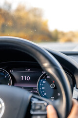 Steering wheel in a car close up, high speed driving on the road.