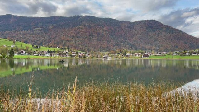 Thiersee lake and mountains on cloudy day in Austria. Peaceful natural landscape with reflection on water