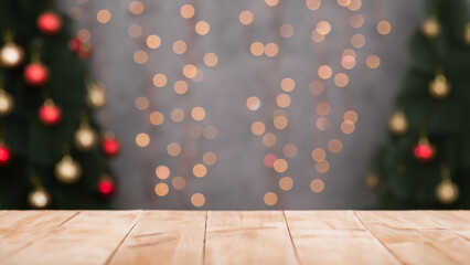 Christmas scene with wooden table for product image montage blurred background with christmas tree decorations and string lights