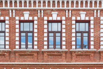 Windows, details of red brick historical building in Yelabuga, Russia