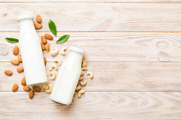Set or collection of various vegan milk almond, cashew, on table background. Vegan plant based milk and ingredients, top view