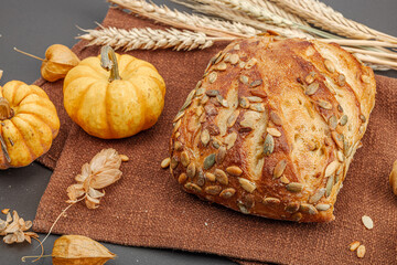 Fresh bread with pumpkin seeds. Home baking concept. Autumn decor