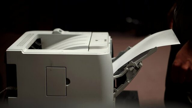 Man using printer or scanner in office . Man printing document