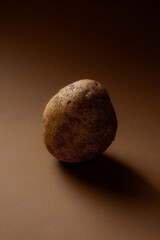 Fototapeta premium Potato on a solid background dramatic lighting