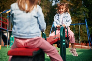 Autumn season. Kids are having fun on the playground
