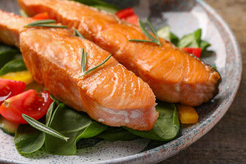 Healthy meal. Tasty grilled salmon with vegetables and spinach on wooden table, closeup