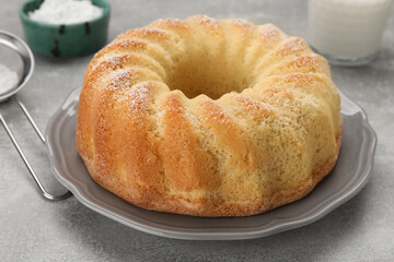 Delicious freshly baked sponge cake on gray table, closeup