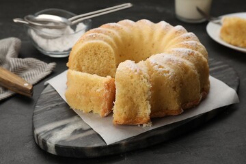 Delicious freshly baked sponge cake on black table