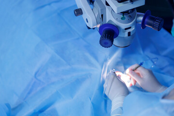 Lasik treatment. Laser vision correction. Doctor examines fundus in microscope, patient under...