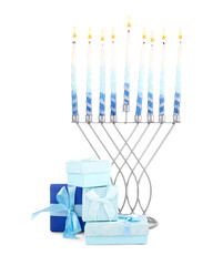 Hanukkah celebration. Menorah with candles and gift boxes isolated on white