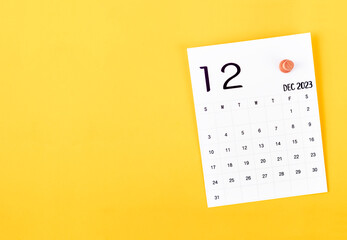 December 2023 calendar and wooden push pin.