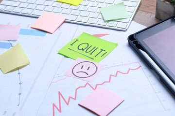 Colorful paper with words I Quit lying on the office desk 