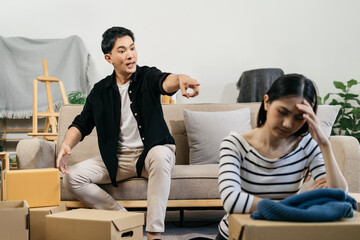 Unhappy young couple sitting apart, having problems in relationship, thinking of breaking up or...