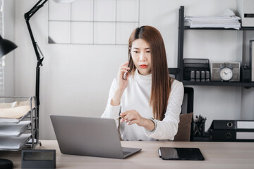 Young woman sitting at desk in the office.