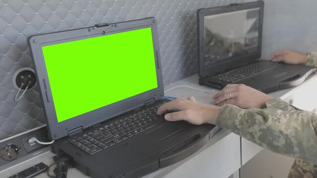 A military man controls a drone on a laptop. Military drone control. Military drone control point.