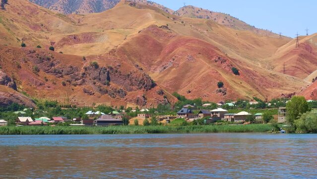 Beautiful view of Nurek river with blue lake and high mountains against the sky