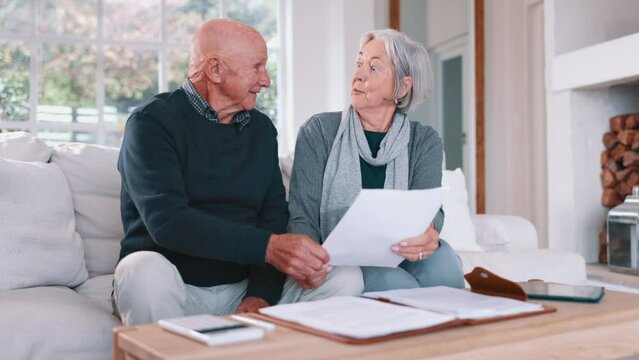 Senior couple, planning bills and home budget, insurance documents or talking of asset management on sofa. Elderly man and woman with paperwork for pension funding, retirement contract or mortgage