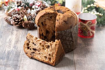 Christmas panettone cake with chocolate chips on wooden table