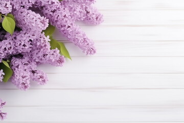 Greeting card  with frame of mauve lilac flowers on white wooden background. Copy space