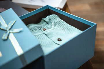 Blue children's clothes in a blue box.